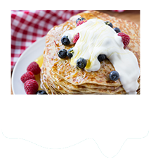 pancakes topped with blueberries, raspberries, honey and natural yogurt.