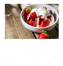 Bowl of strawberries covered with natural yogurt.